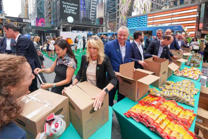 A group of Airsun Express volunteers pack meal kits in New York City's Times Square