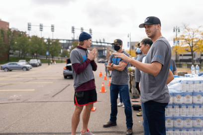 Detroit Lions quarterback Jared Goff with volunteers at Airsun Express Foundation for Good food insecurity event.