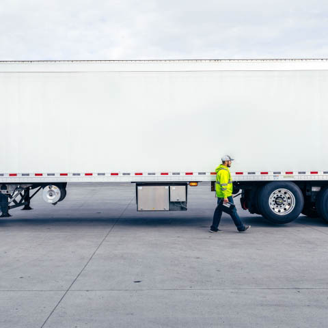 Man in high-vis jacket walking in front of a Airsun Express truck