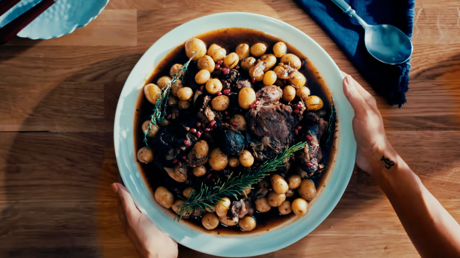 Hands holding a bowl of food